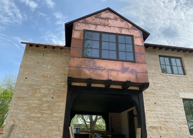 Copper metal panel facade on a stone building for Skylight Installation in Winder