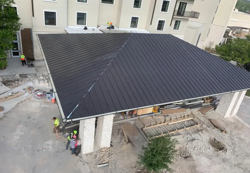 Metal roofing installation team working on a commercial building in Winder